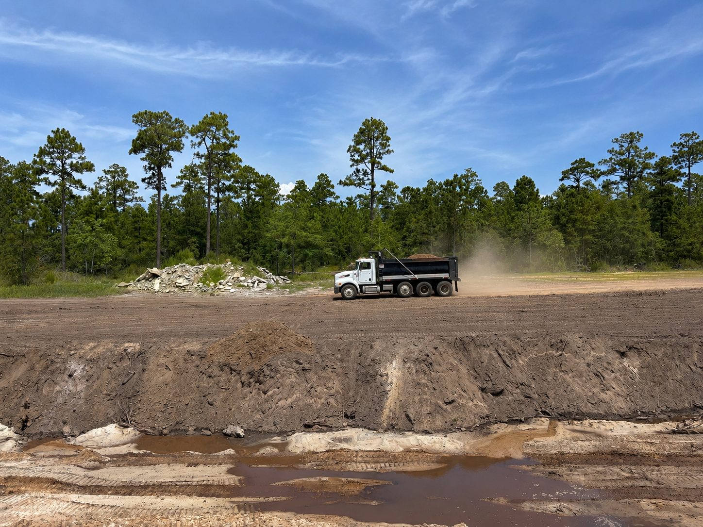 Loaded dump truck hauling sand